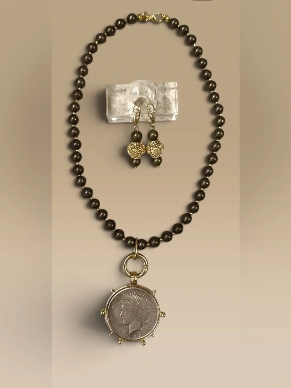 Large silver tone coin in gold tone setting on pyrite necklace with earrings